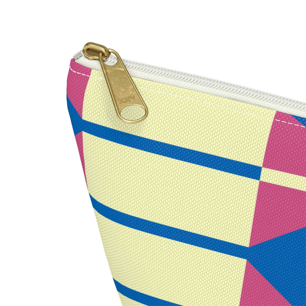 Close-up of the gold zipper pull and yellow, pink and blue geometric print on the makeup bag